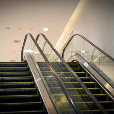 What is the difference between an escalator and a moving sidewalk?
